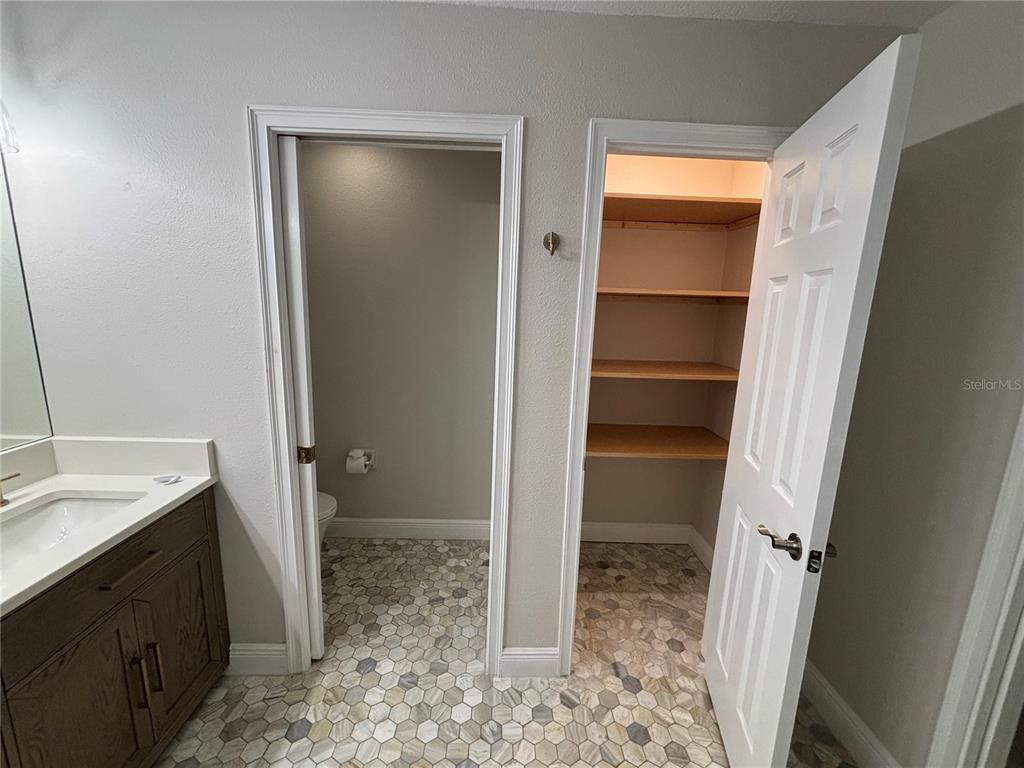 6536 Moorings Point Circle, Unit 101 Lakewood Ranch, FL 34202 - Photo 31 of 34 a spacious bathroom with a granite countertop sink and a mirror