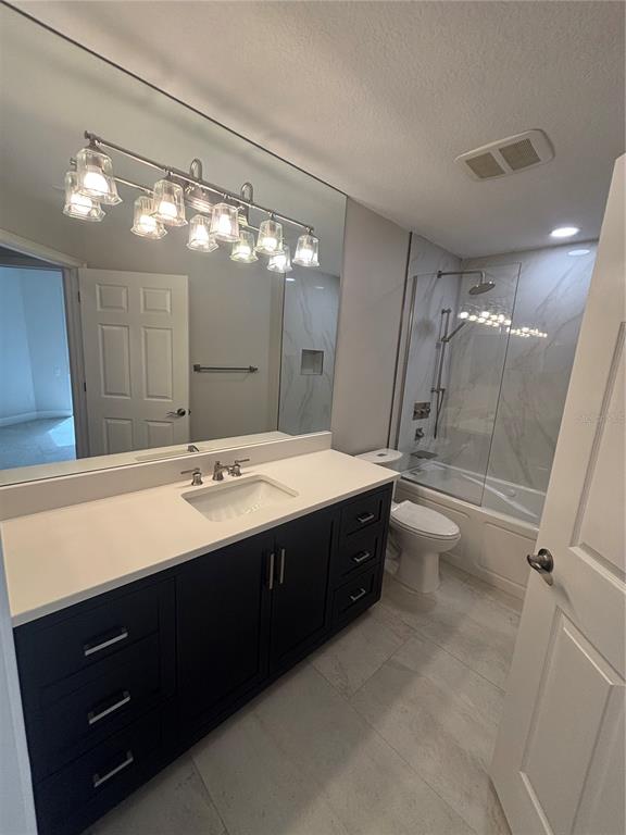6536 Moorings Point Circle, Unit 101 Lakewood Ranch, FL 34202 - Photo 8 of 34 a bathroom with a double vanity sink toilet mirror and shower