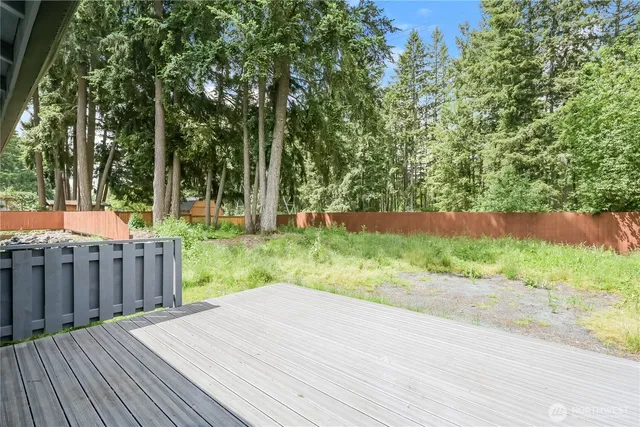 a view of a backyard with wooden fence