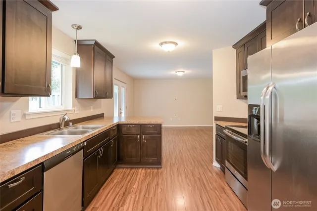 a kitchen with a sink refrigerator and microwave