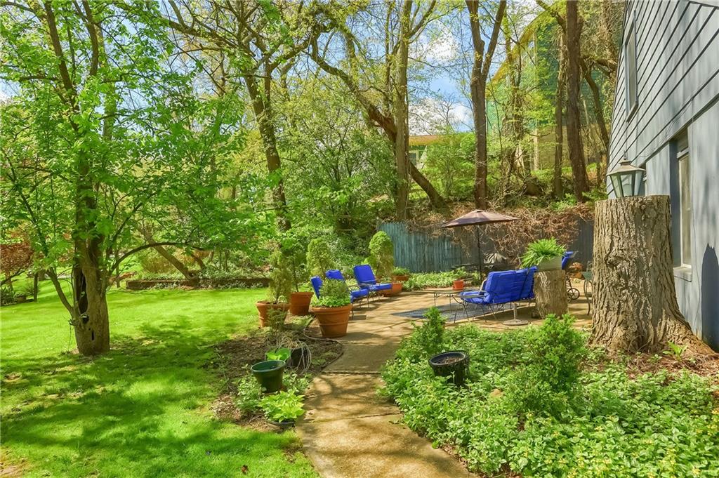 2766 Beaver Grade Road Coraopolis, PA 15108 - Photo 34 of 41 a backyard of a house with table and chairs and a large tree