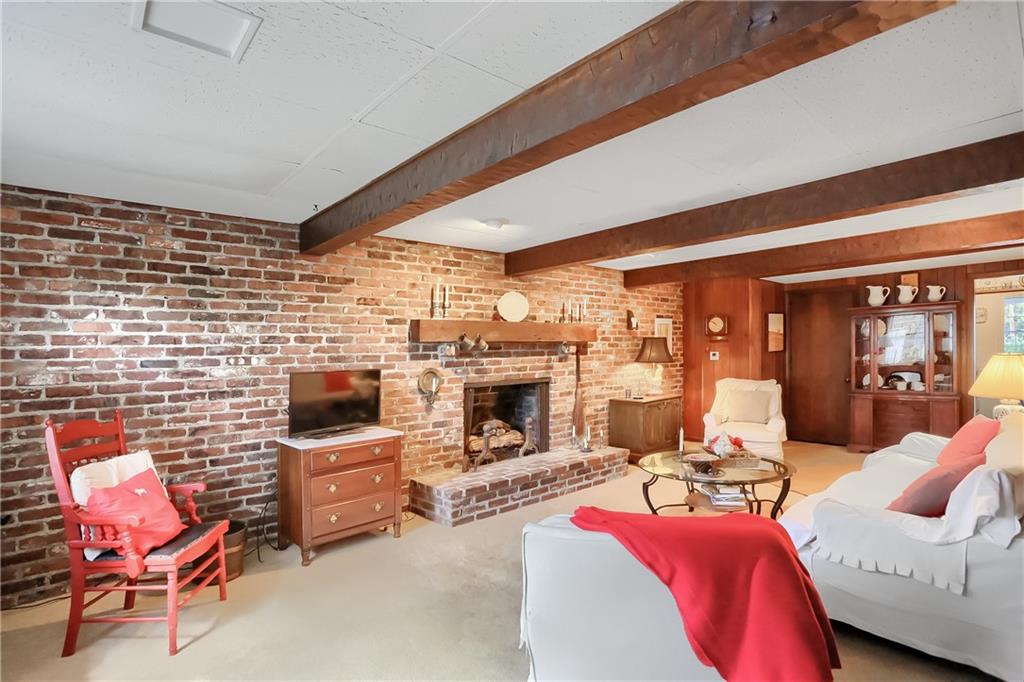 2766 Beaver Grade Road Coraopolis, PA 15108 - Photo 8 of 41 a living room with furniture a fireplace and a flat screen tv