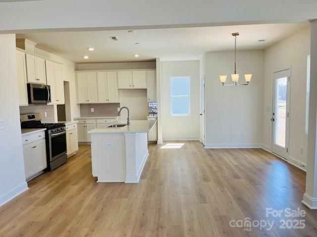 2019 Puddle Pond Road Indian Trail, NC 28079 - Photo 2 of 11 a kitchen with stainless steel appliances granite countertop a stove top oven a refrigerator a sink and dishwasher with wooden floor
