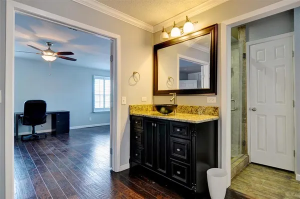 a bathroom with a granite countertop sink a mirror and a vanity