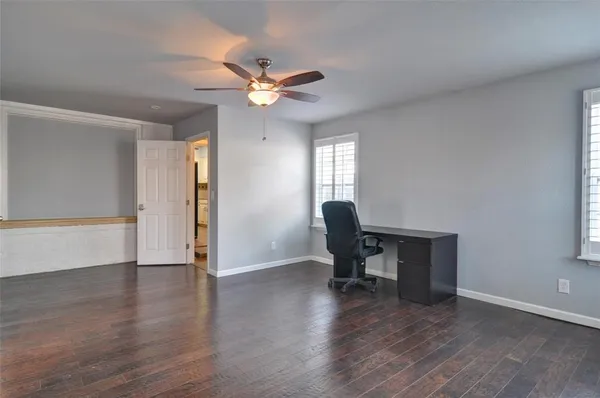 a view of a workspace with furniture and a window