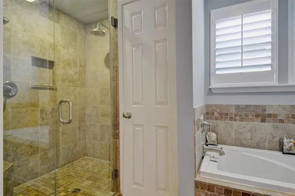 a bathroom with a bathtub and shower