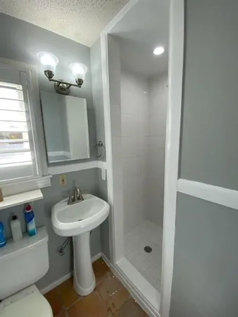 a bathroom with a sink toilet and shower