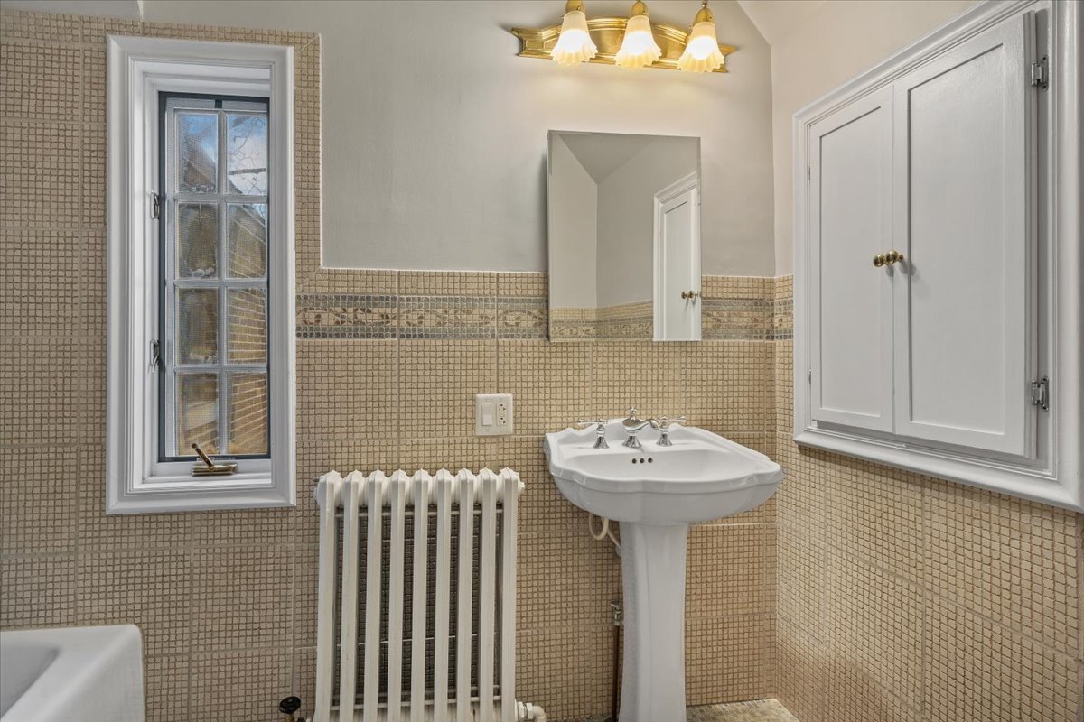 312 Sterling Road Kenilworth, IL 60043 - Photo 32 of 51 a bathroom with a sink and a mirror