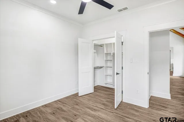 an empty room with wooden floor and a window