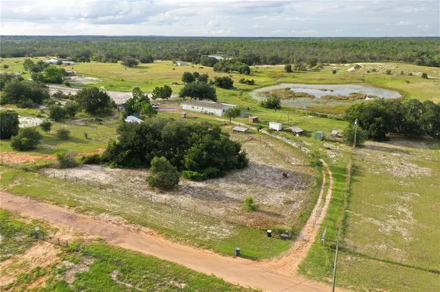 a kitchen with granite countertop a sink window and cabinets