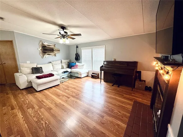a kitchen with a fireplace and a flat screen tv