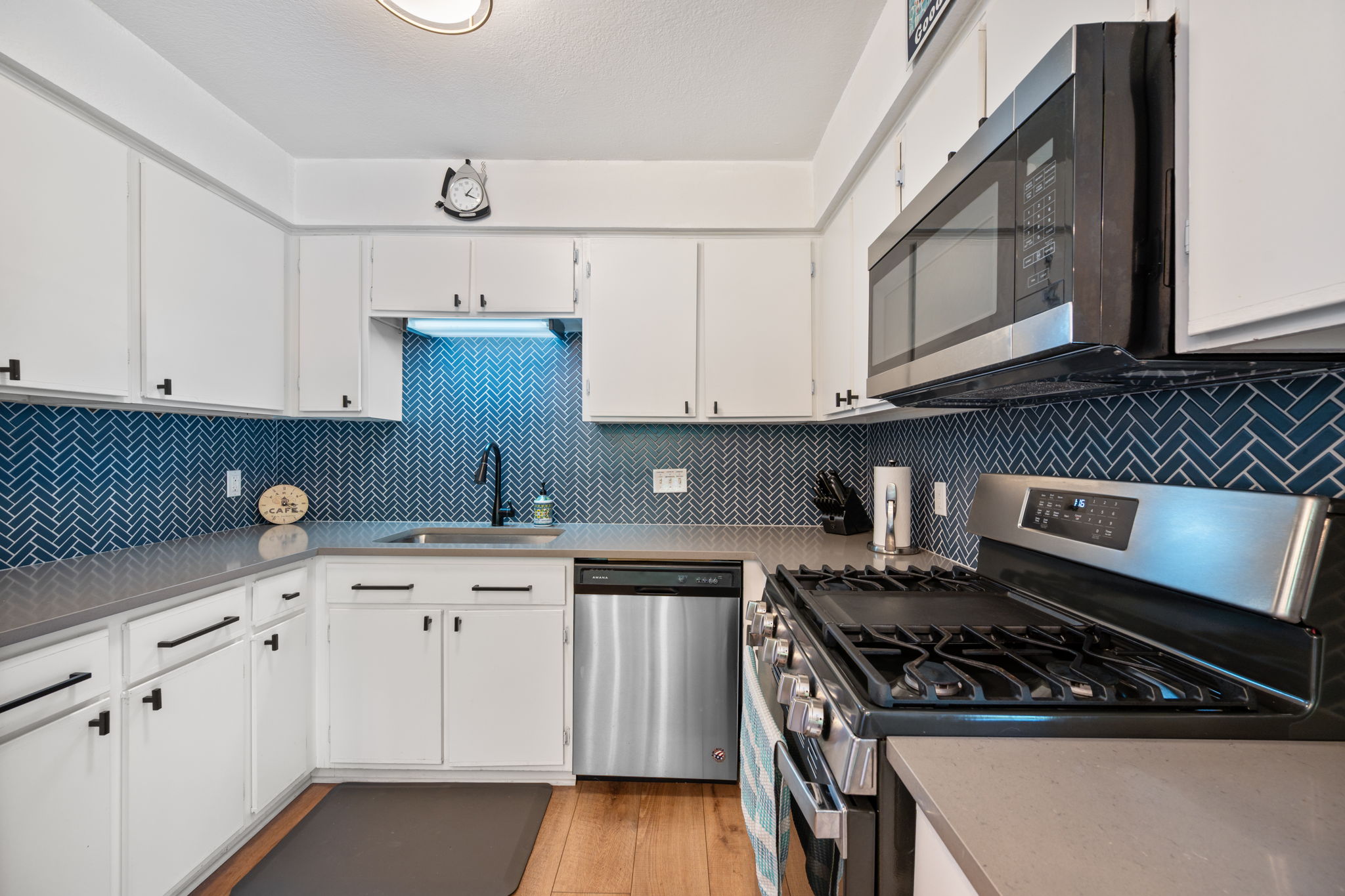 2801 Cornish Circle Austin, TX 78745 - Photo 12 of 29 a kitchen with stainless steel appliances granite countertop a stove a sink and white cabinets