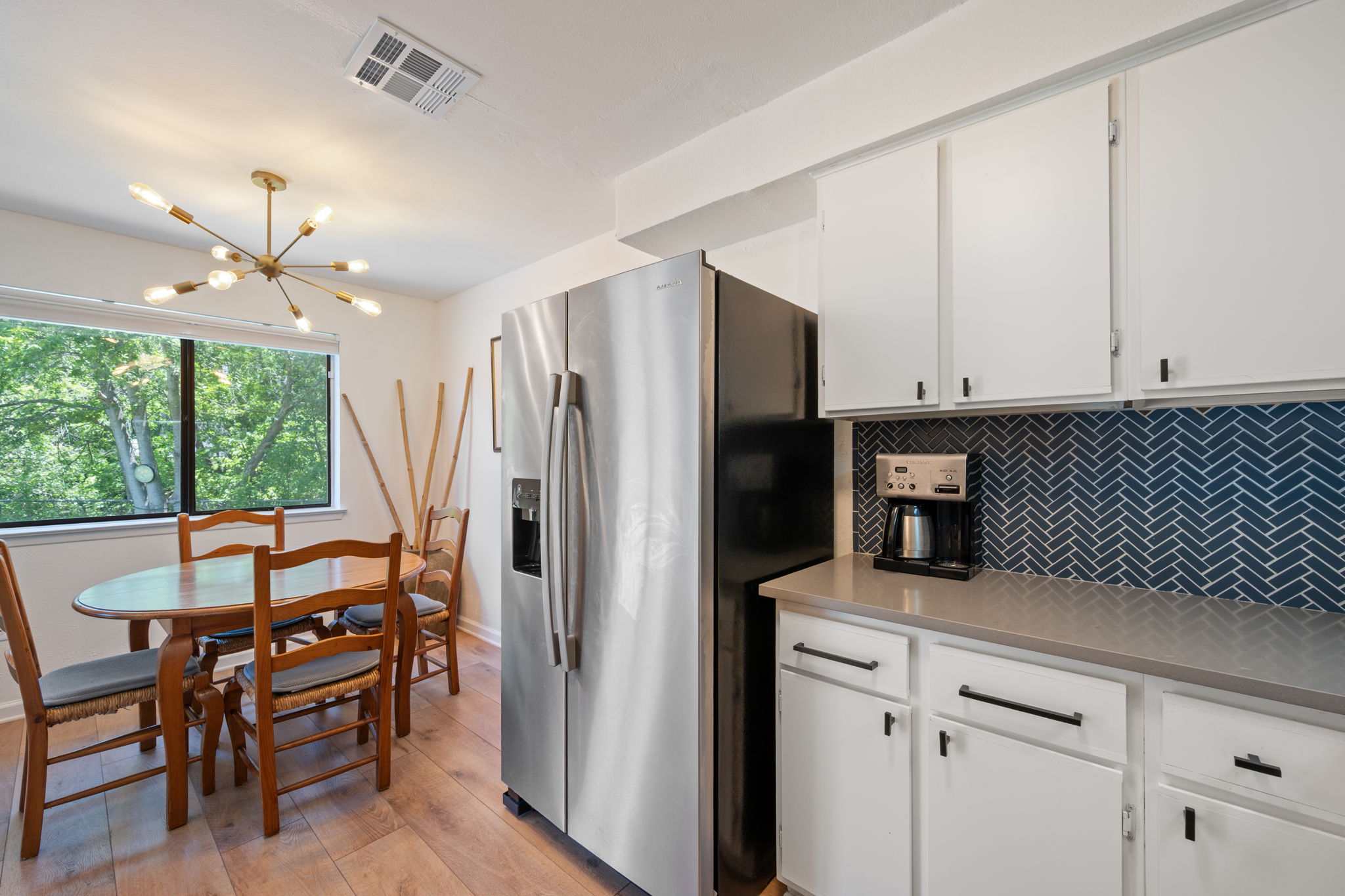 2801 Cornish Circle Austin, TX 78745 - Photo 14 of 29 a kitchen with stainless steel appliances granite countertop a refrigerator a sink a stove and white cabinets with wooden floor