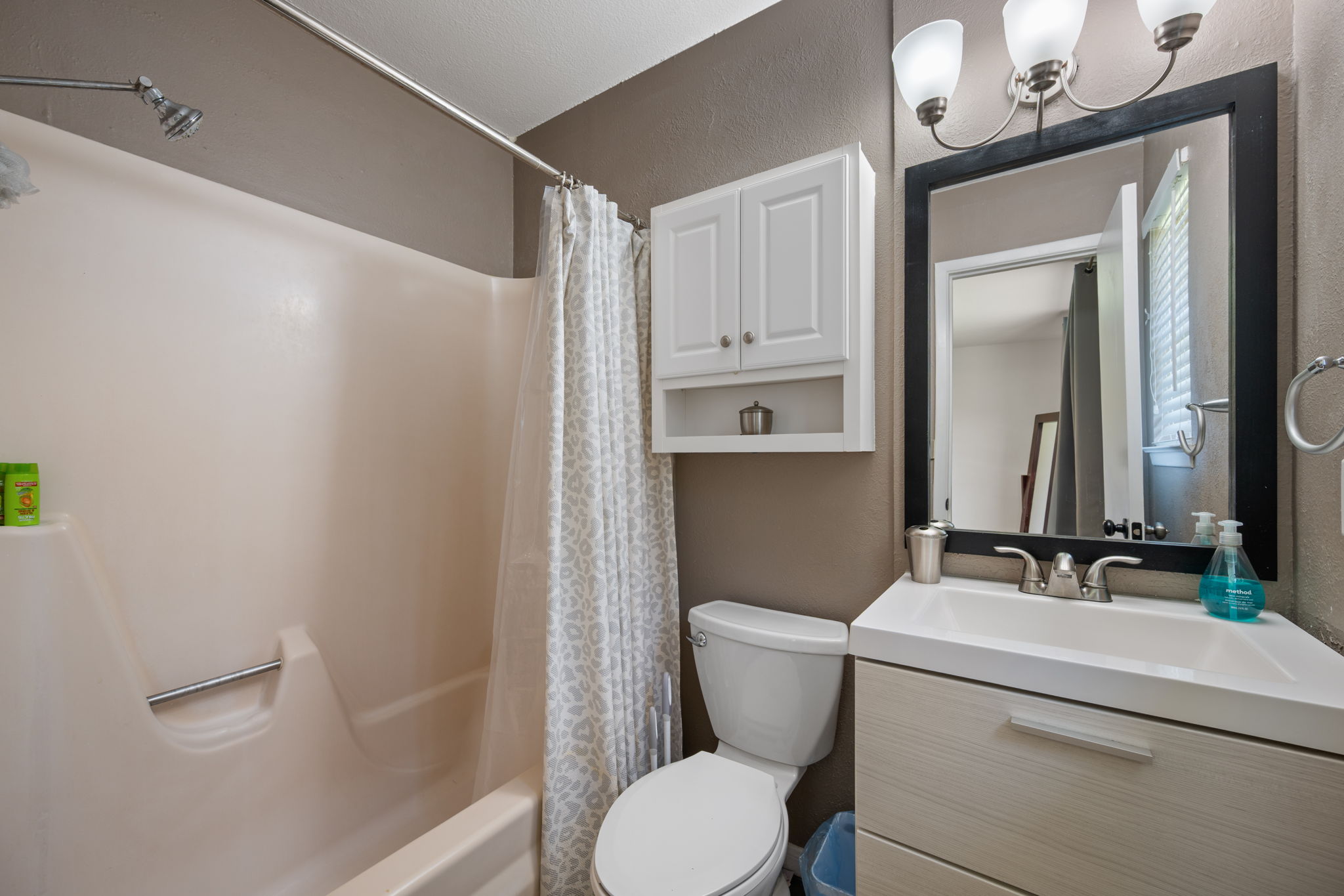 2801 Cornish Circle Austin, TX 78745 - Photo 17 of 29 a bathroom with a toilet sink shower and mirror