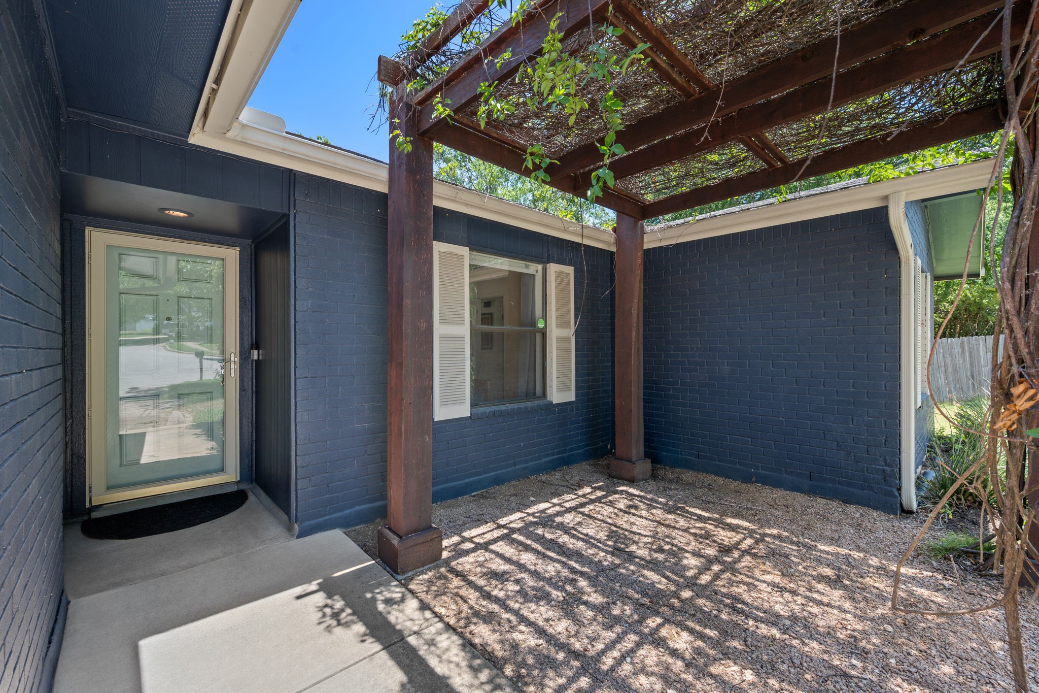 2801 Cornish Circle Austin, TX 78745 - Photo 3 of 29 View of exterior entry featuring brick siding and a pergola