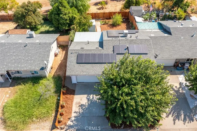 an aerial view of a house with a yard and balcony