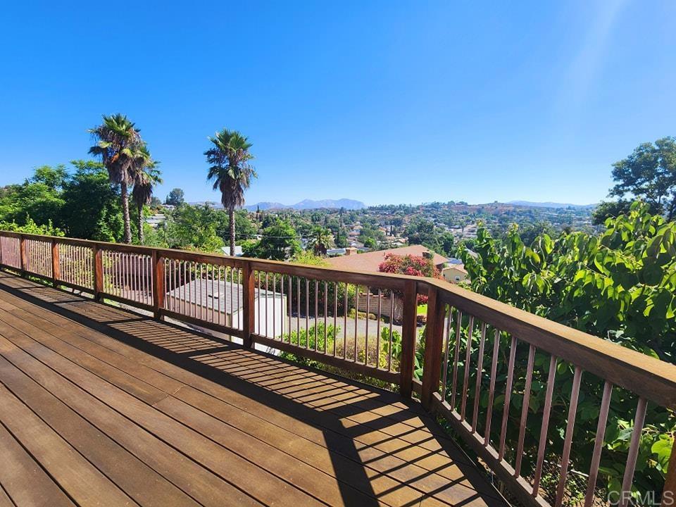 a view of balcony with wooden floor and fence