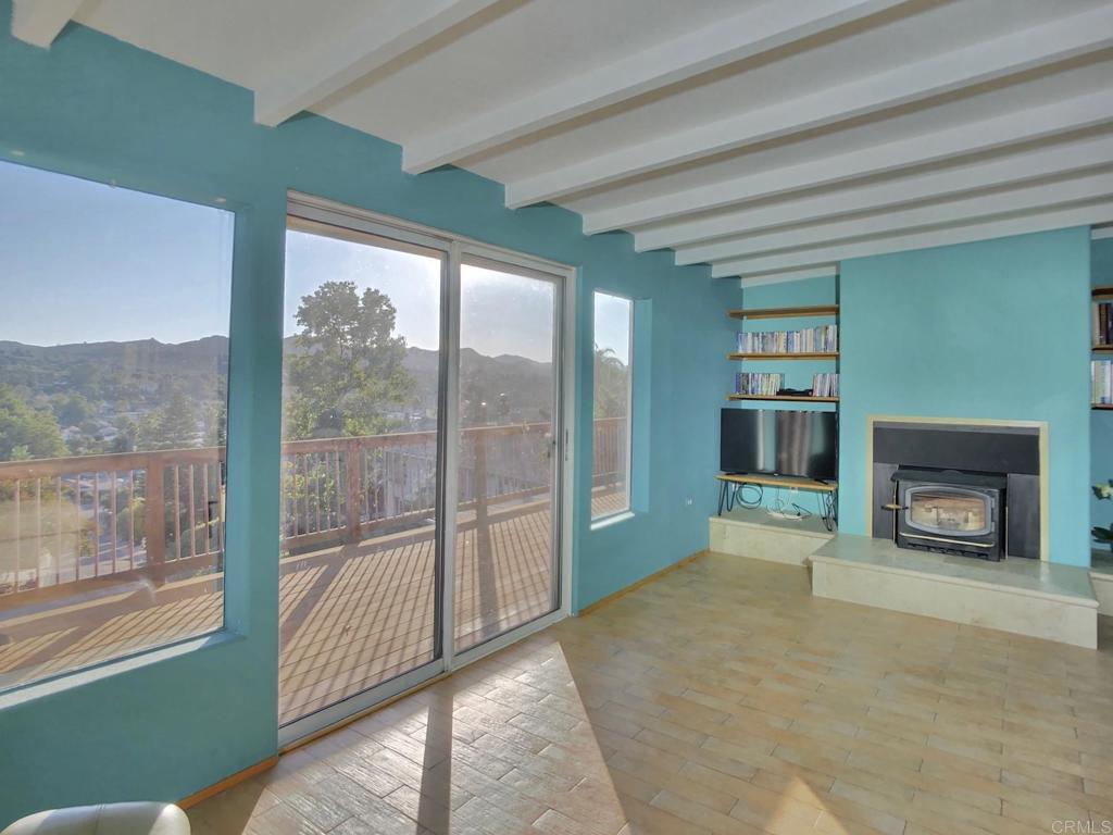 8242 Sunset Road Lakeside, CA 92040 - Photo 13 of 48 a view of an empty room with a fireplace and a window