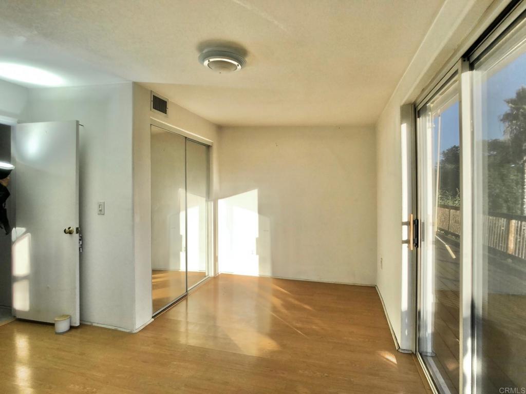 8242 Sunset Road Lakeside, CA 92040 - Photo 16 of 48 a view of empty room with wooden floor and windows