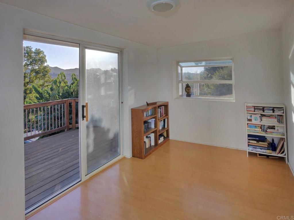 8242 Sunset Road Lakeside, CA 92040 - Photo 18 of 48 an empty room with bookshelf and a window