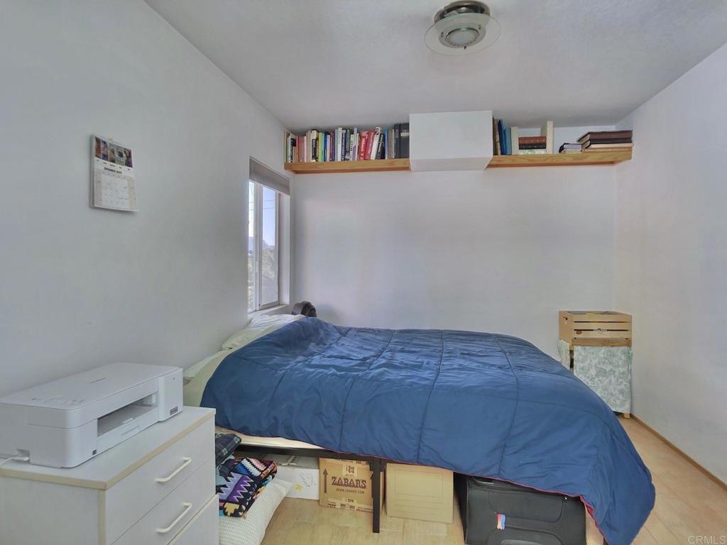 8242 Sunset Road Lakeside, CA 92040 - Photo 19 of 48 a bedroom with a bed and cabinets