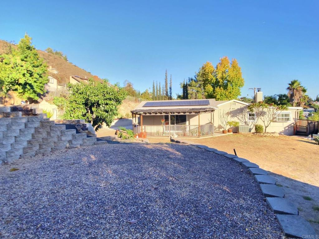 8242 Sunset Road Lakeside, CA 92040 - Photo 40 of 48 a white house with a large tree in front of it