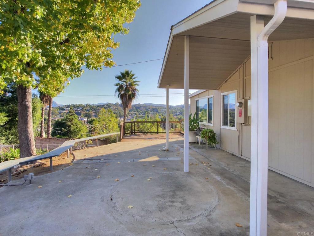 8242 Sunset Road Lakeside, CA 92040 - Photo 46 of 48 a view of a garden with a bench under an umbrella