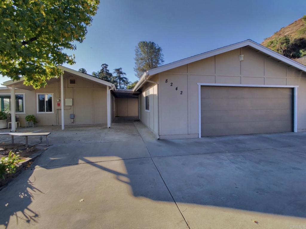8242 Sunset Road Lakeside, CA 92040 - Photo 6 of 48 a view of a house with a yard and garage