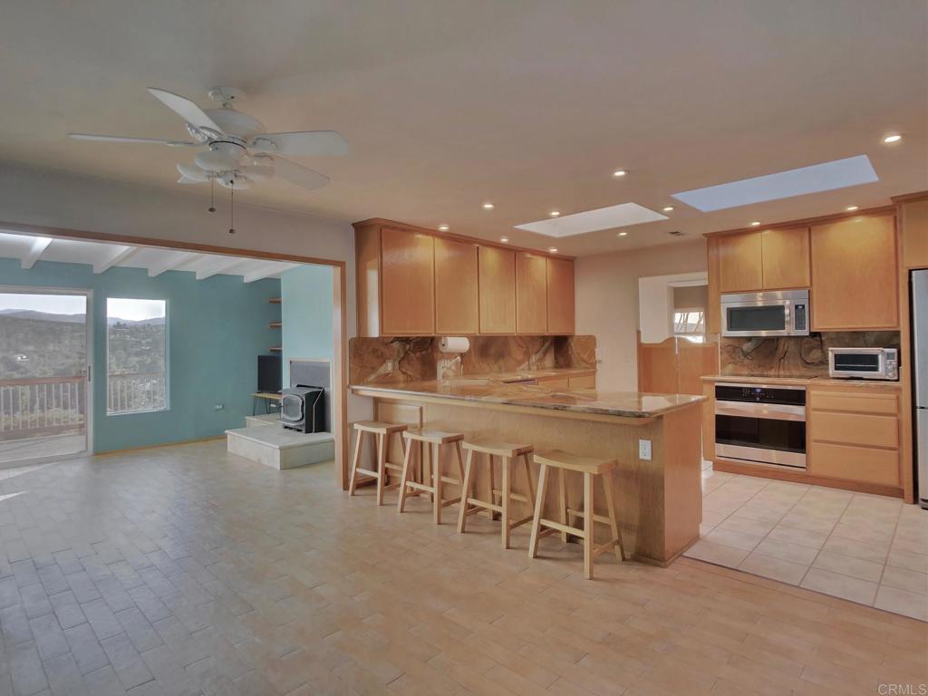 8242 Sunset Road Lakeside, CA 92040 - Photo 8 of 48 a large kitchen with stainless steel appliances lots of counter space and breakfast area
