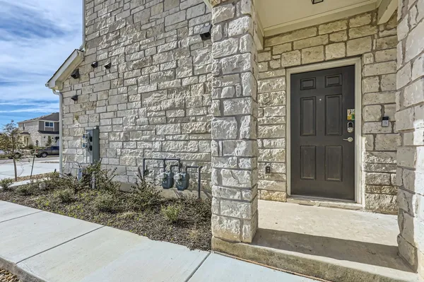 a front view of a house with a brick wall