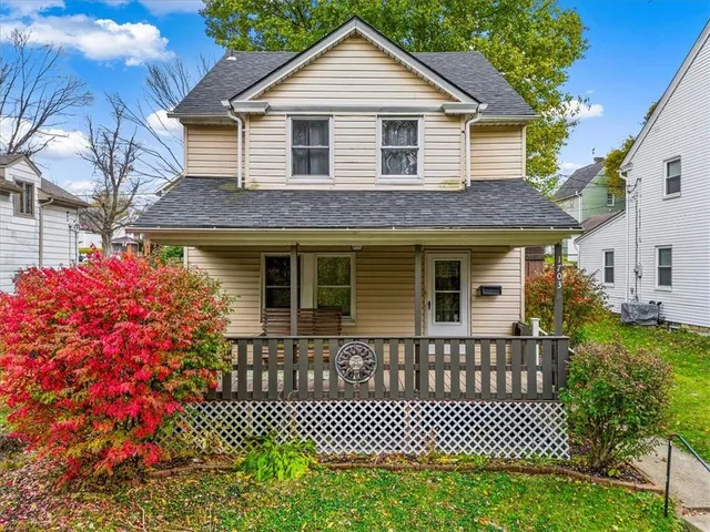 a front view of a house with a garden