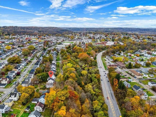 a view of a livingroom with wooden floor and stairs