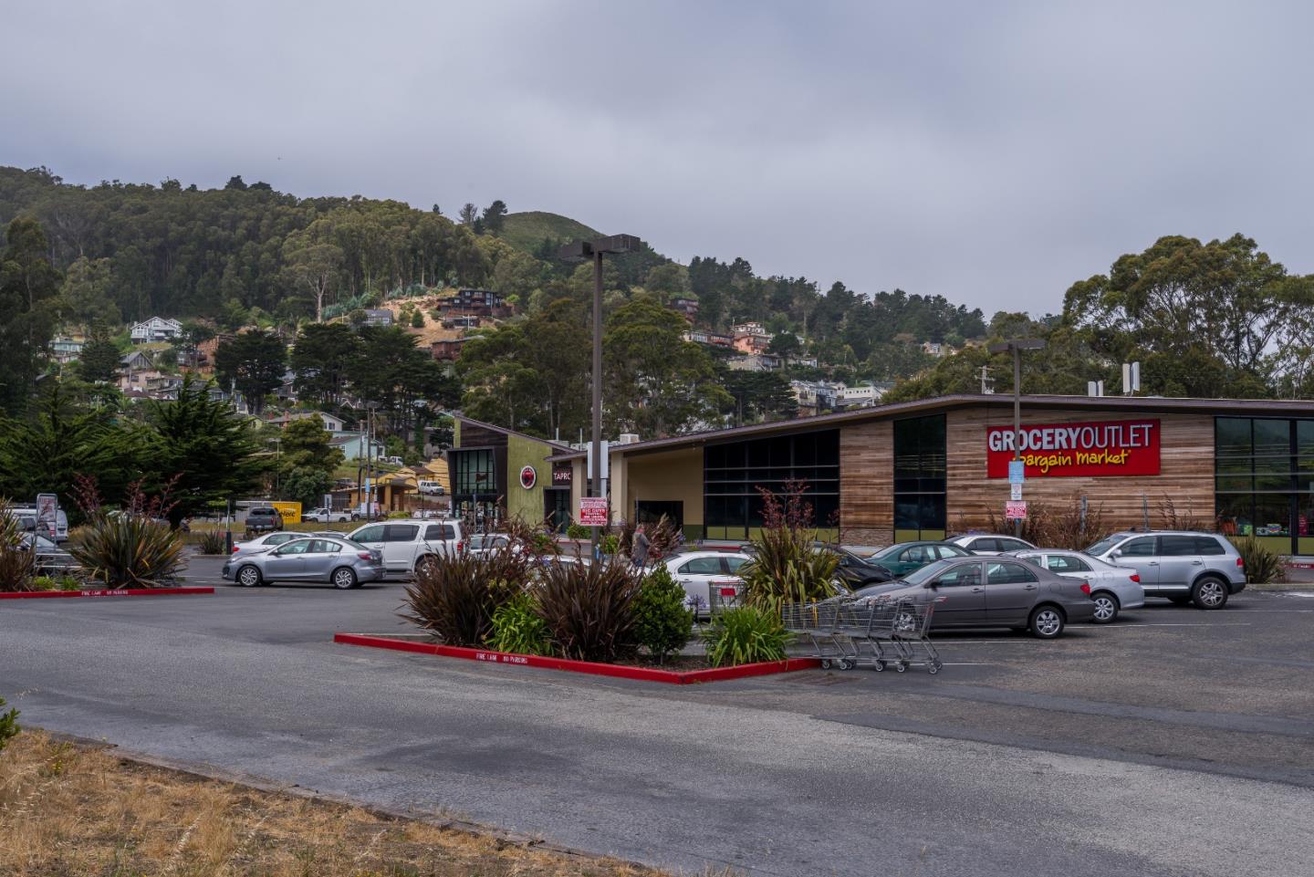 276 Kent Road Pacifica, CA 94044 - Photo 14 of 15 a view of road with card parked on side and retail shops