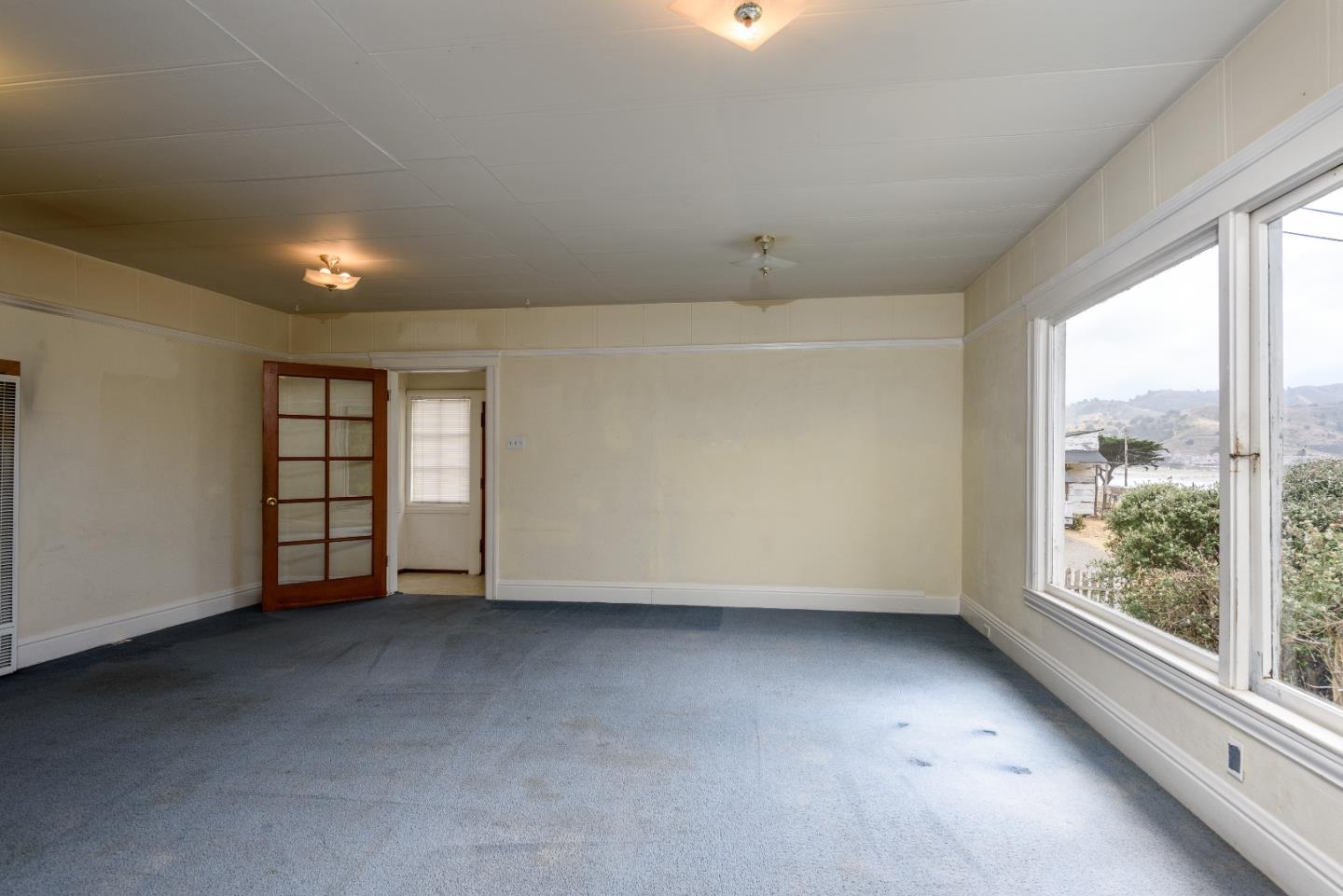 276 Kent Road Pacifica, CA 94044 - Photo 4 of 15 an empty room with windows