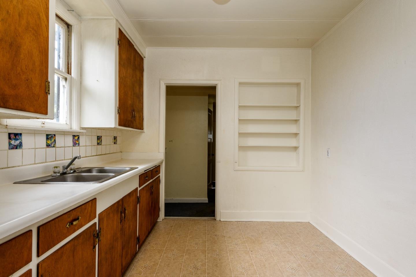 276 Kent Road Pacifica, CA 94044 - Photo 5 of 15 a kitchen with a sink and cabinets