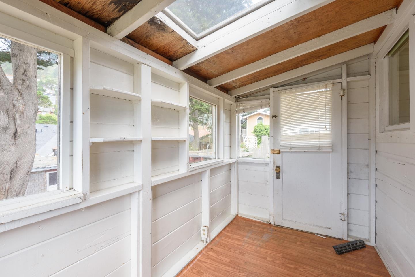 276 Kent Road Pacifica, CA 94044 - Photo 9 of 15 a view of a hallway with wooden floor and staircase