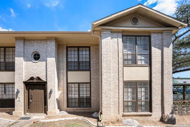 a front view of a house with large windows
