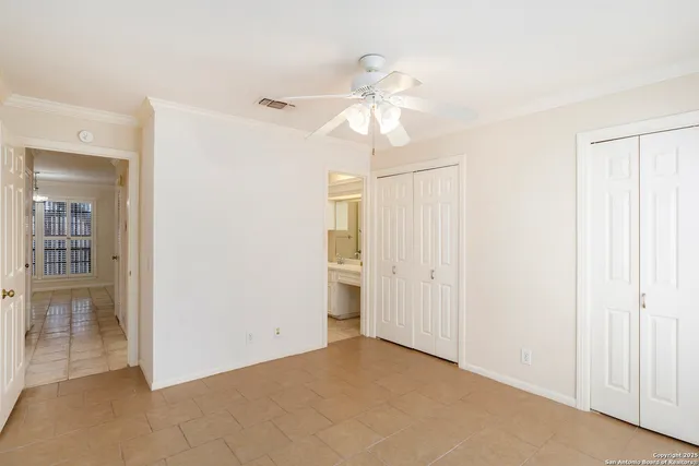 an empty room with fan and entrance