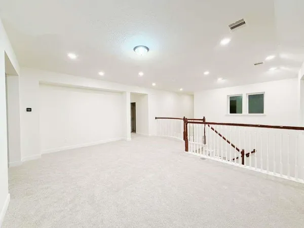 an empty room with windows and closet