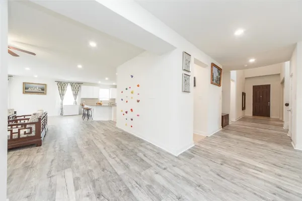 a view of a a dining room with furniture window and wooden floor