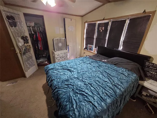 a bedroom with a bed a walk in closet