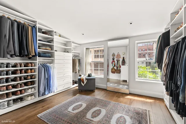 a view of an empty room with a window and storage