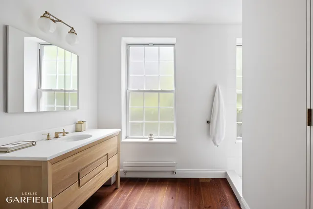 a bathroom with a sink and a window