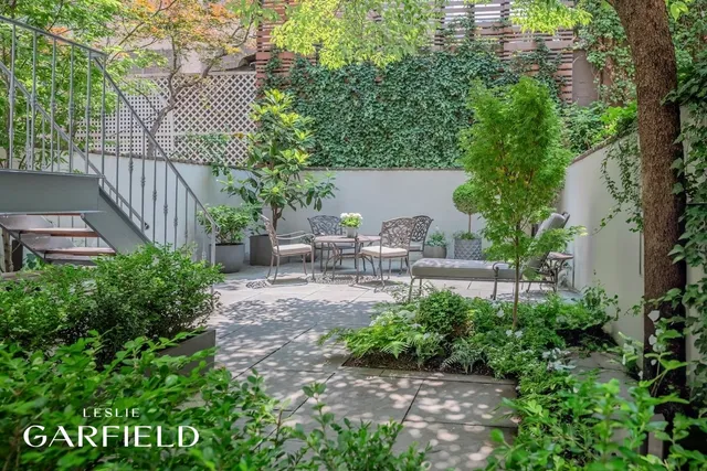 a view of a chair and table in backyard