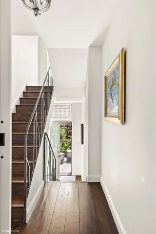 a view of an entryway with wooden floor