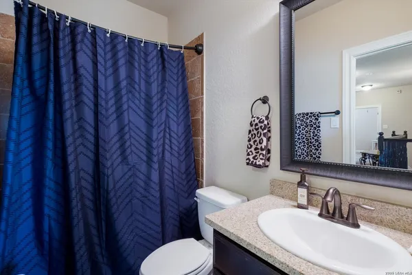 a bathroom with a sink a toilet and a mirror