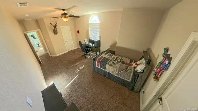 a bedroom with a bed and a chandelier