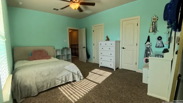 a bedroom with furniture and a wooden floor