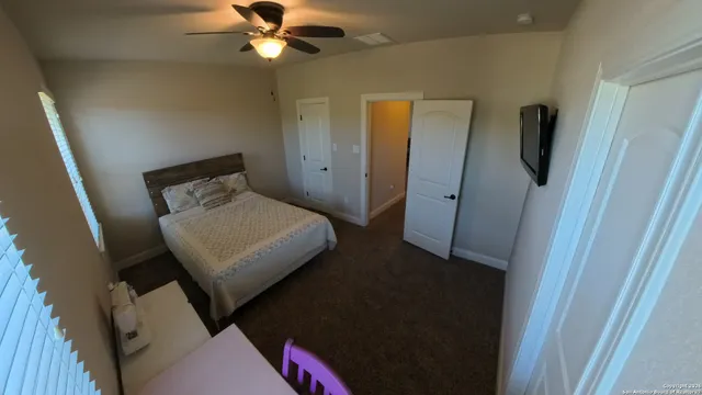 a bedroom with a bed and a flat screen tv