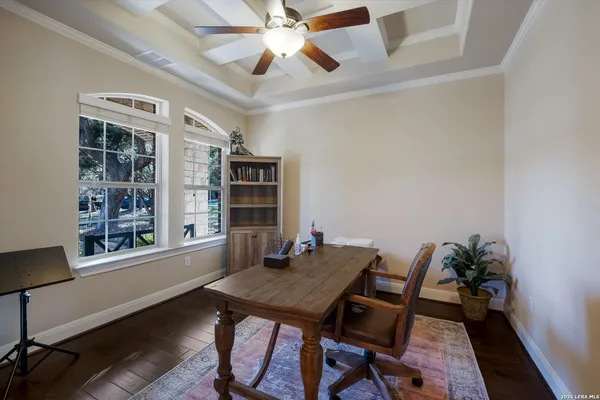 a view of a workspace with furniture and a window